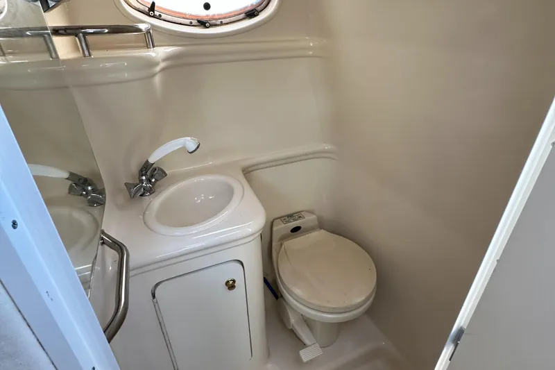 Slide: The Image of 2001 Sea Ray 260 Sundancer bathroom with sink, toilet, and mirror. - 18