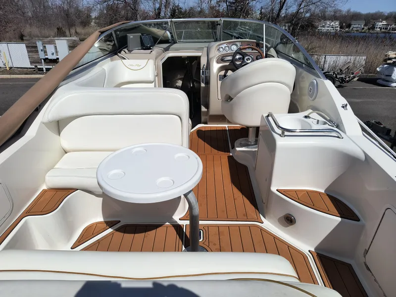 Slide: The Image of 2001 Sea Ray 260 Sundancer boat interior with seating and helm, featuring elegant design. - 4