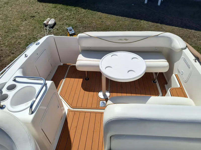 Slide: The Image of 2001 Sea Ray 260 Sundancer boat interior with seating and table on teak deck. - 6