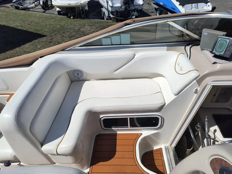 Slide: The Image of 2001 Sea Ray 260 Sundancer boat interior with white seating and wood accents. - 7