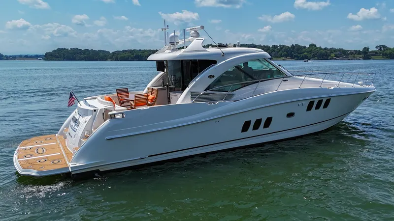 Slide: The Image of 2007 Sea Ray 60 Sundancer yacht on calm water, clear sky background. - 12