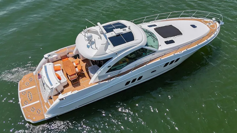 Slide: The Image of 2007 Sea Ray 60 Sundancer yacht cruising on open water, aerial view. - 13