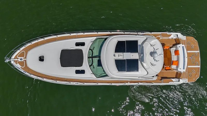 Slide: The Image of Aerial view of 2007 Sea Ray 60 Sundancer yacht on green water. - 14