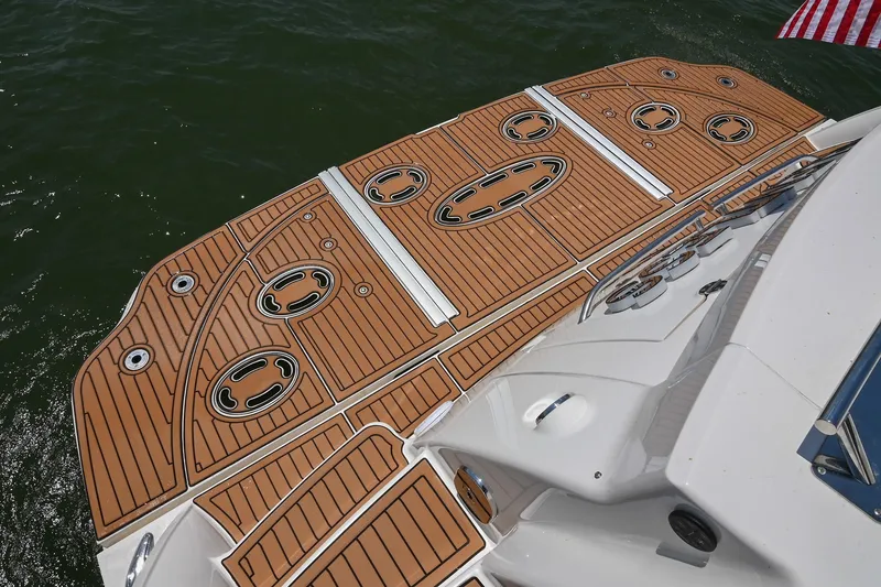 Slide: The Image of 2007 Sea Ray 60 Sundancer swim platform with teak decking, on calm water. - 15