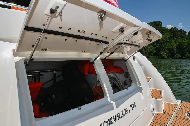 Slide: The Image of Open storage compartment on 2007 Sea Ray 60 Sundancer boat, Knoxville, TN, near lush shoreline. - 17
