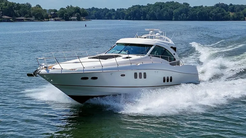 Slide: The Image of 2007 Sea Ray 60 Sundancer yacht cruising on a serene lake. - 2