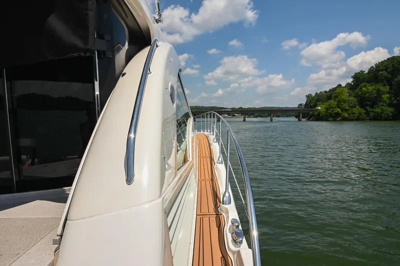 Slide: The Image of 2007 Sea Ray 60 Sundancer yacht on a scenic river under a blue sky. - 21