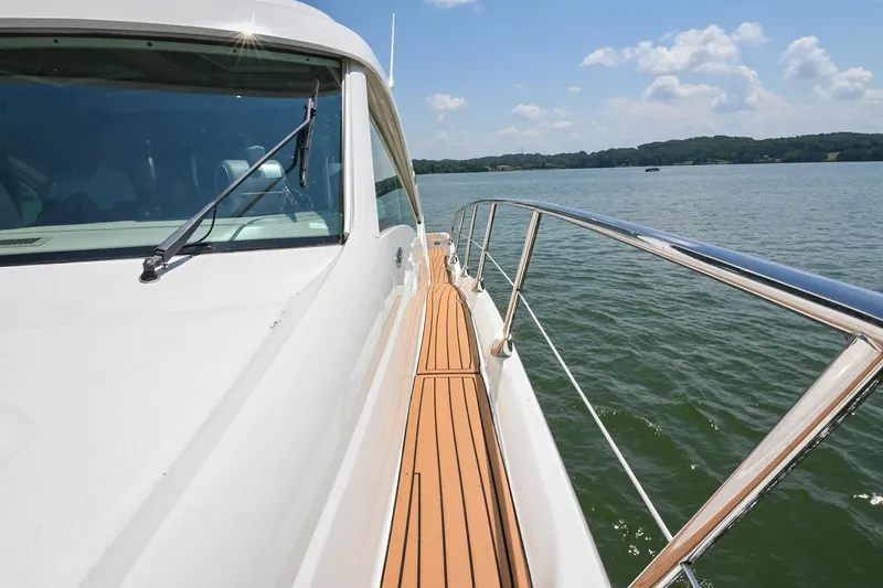 Slide: The Image of 2007 Sea Ray 60 Sundancer yacht on calm water, sunny day, sleek design. - 27