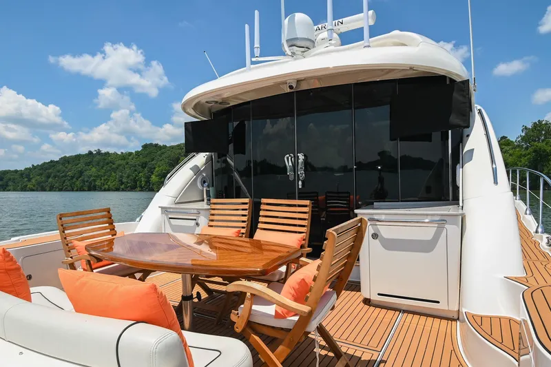 Slide: The Image of Luxurious 2007 Sea Ray 60 Sundancer yacht with elegant outdoor seating and scenic water view. - 28