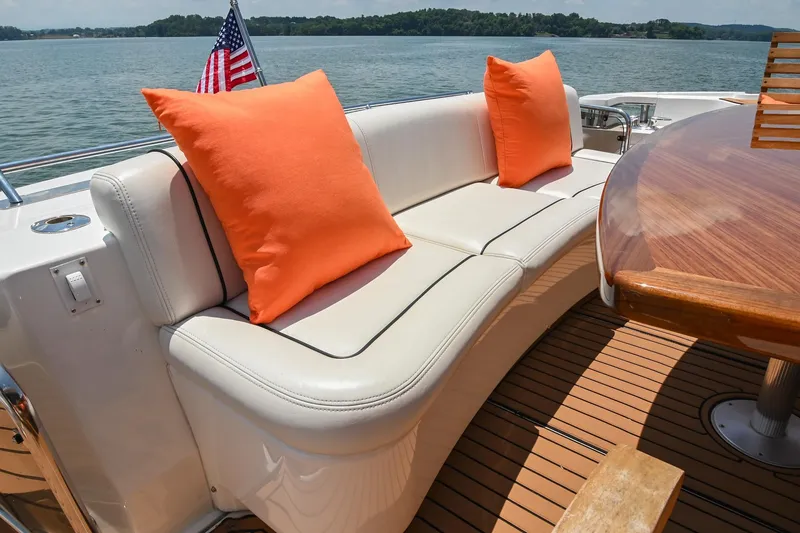 Slide: The Image of Luxurious 2007 Sea Ray 60 Sundancer yacht deck with white seating and orange cushions. - 30