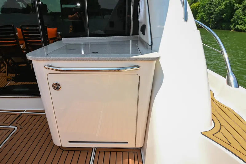 Slide: The Image of 2007 Sea Ray 60 Sundancer yacht deck with outdoor kitchenette and seating area. - 32