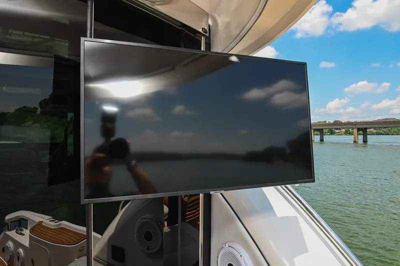 Slide: The Image of Outdoor TV on 2007 Sea Ray 60 Sundancer yacht, with scenic water and bridge view. - 34