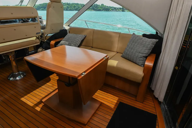 Slide: The Image of Interior of 2007 Sea Ray 60 Sundancer yacht with sofa and wooden table. - 39