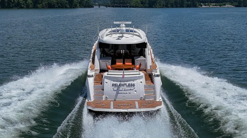 Slide: The Image of 2007 Sea Ray 60 Sundancer yacht cruising on a serene lake. - 4