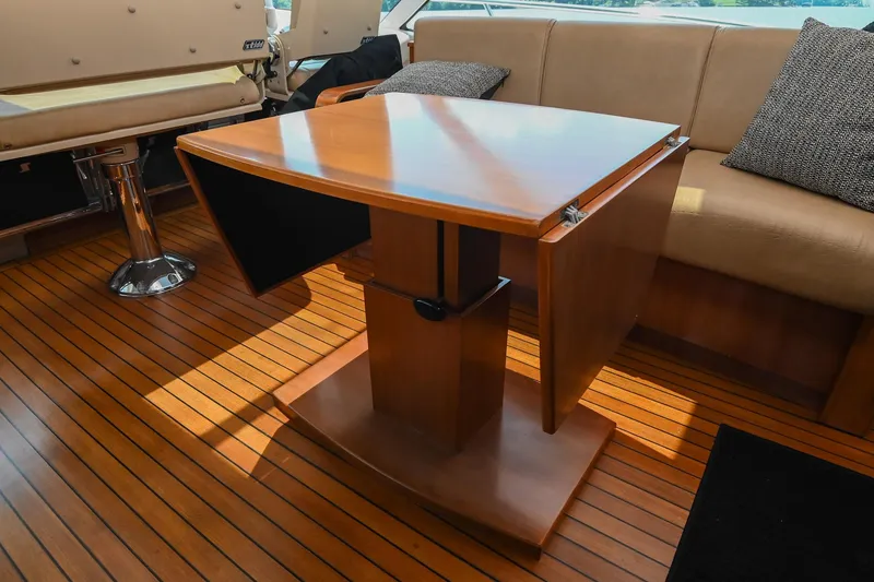 Slide: The Image of Interior of 2007 Sea Ray 60 Sundancer with wooden table and seating area. - 41