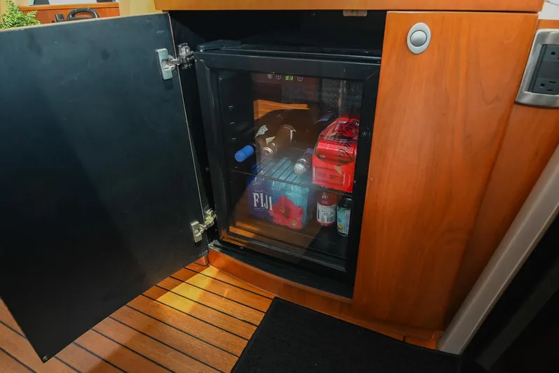 Slide: The Image of Mini fridge stocked with beverages inside 2007 Sea Ray 60 Sundancer yacht. - 49