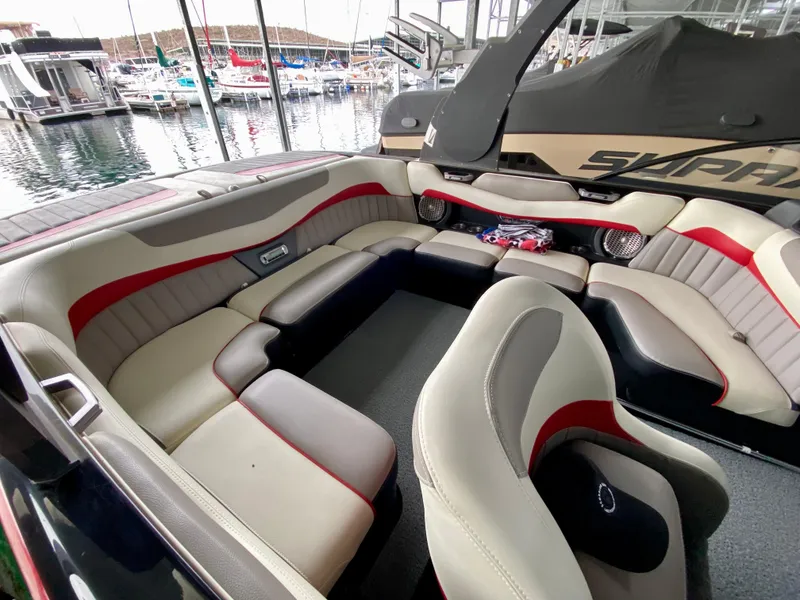 Slide: The Image of 2015 Malibu Wakesetter 22 MXZ interior with luxurious seating at a marina. - 15