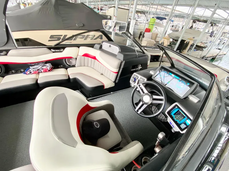 Slide: The Image of 2015 Malibu Wakesetter 22 MXZ boat interior with modern dashboard and seating. - 16