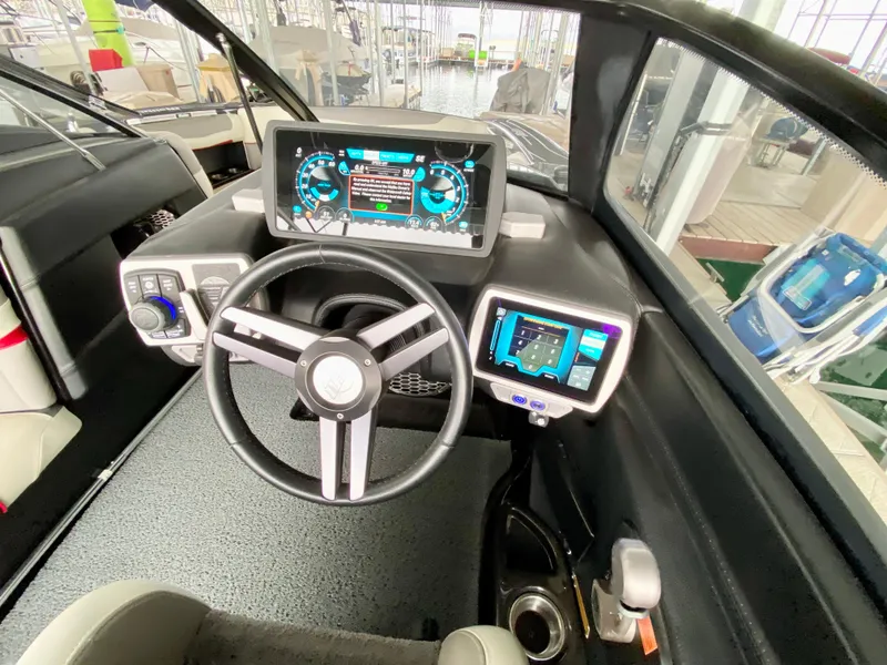 Slide: The Image of 2015 Malibu Wakesetter 22 MXZ dashboard with advanced digital controls and steering wheel. - 17