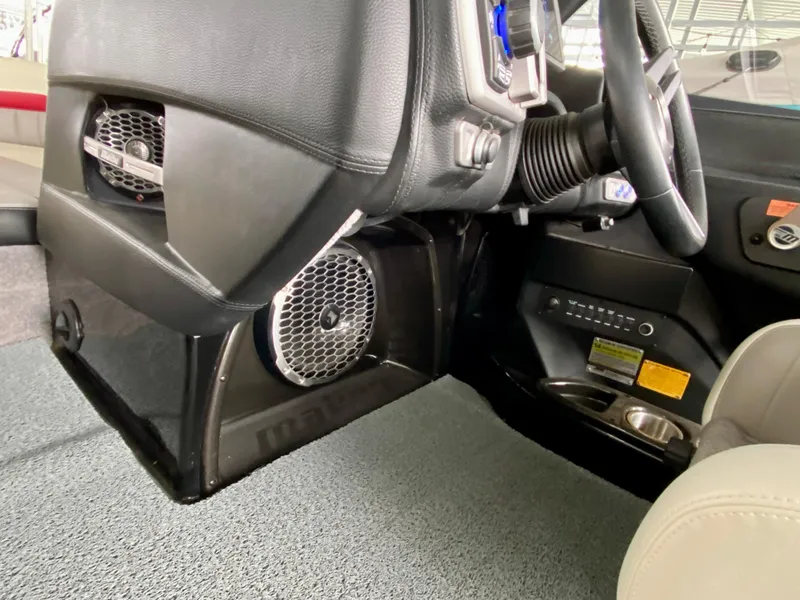 Slide: The Image of 2015 Malibu Wakesetter 22 MXZ interior, featuring speaker system and steering wheel. - 21