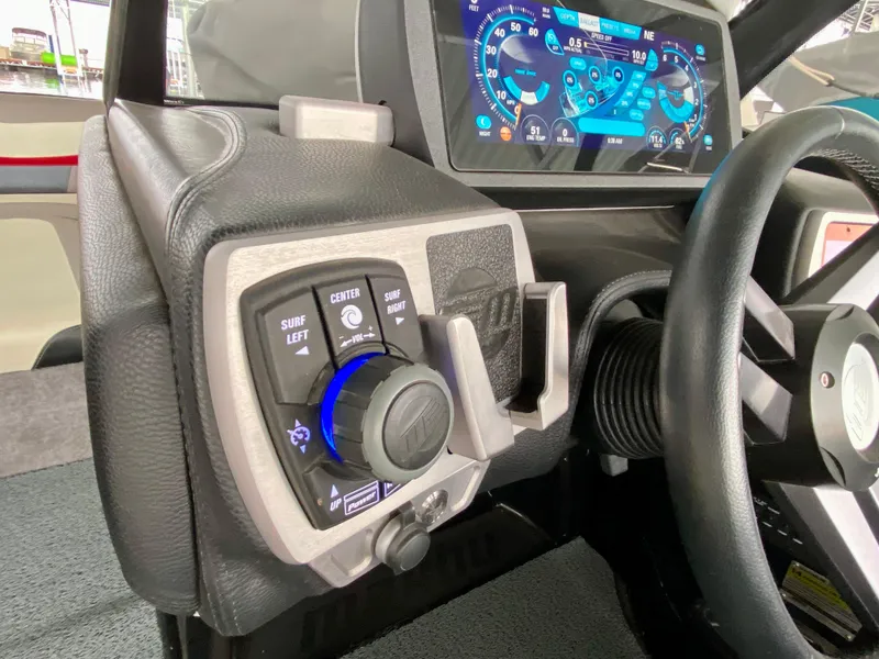 Slide: The Image of 2015 Malibu Wakesetter 22 MXZ dashboard with control panel and digital display. - 22