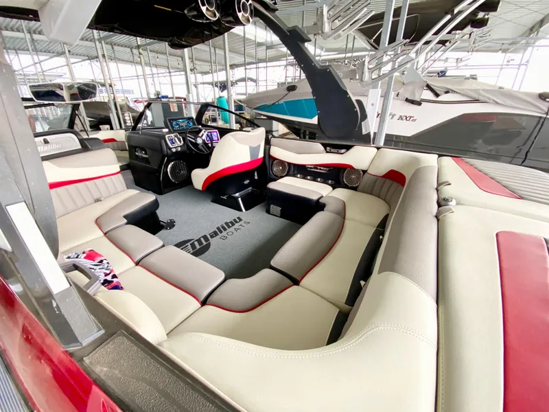 Slide: The Image of 2015 Malibu Wakesetter 22 MXZ interior with plush seating and modern dashboard. - 9