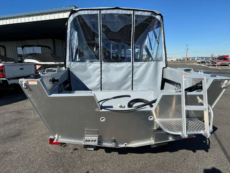 Slide: The Image of 2025 Hewescraft 160 Sportsman boat, rear view, parked outdoors. - 3