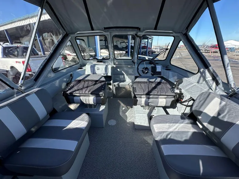 Slide: The Image of 2025 Hewescraft 160 Sportsman interior with seating and steering wheel. - 5