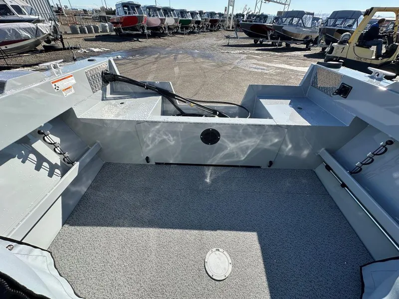 Slide: The Image of 2025 Hewescraft 160 Sportsman boat interior, showcasing spacious deck and storage compartments. - 8