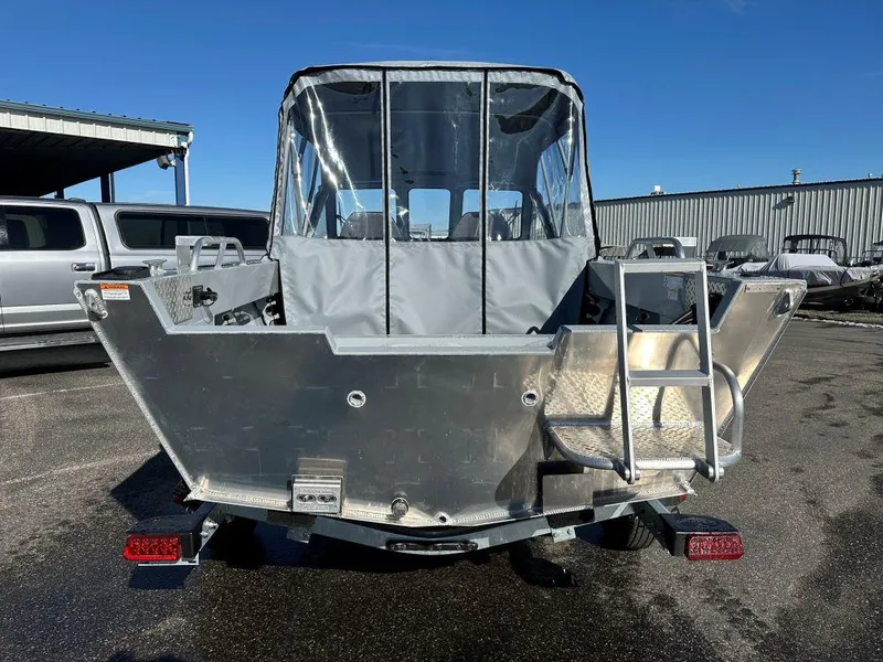 Slide: The Image of 2025 Hewescraft 180 Sportsman boat, rear view, parked outdoors on a sunny day. - 3