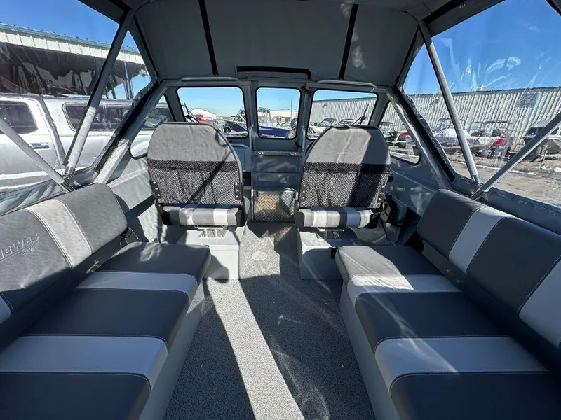 Slide: The Image of 2025 Hewescraft 180 Sportsman interior with gray seating and spacious cabin design. - 5