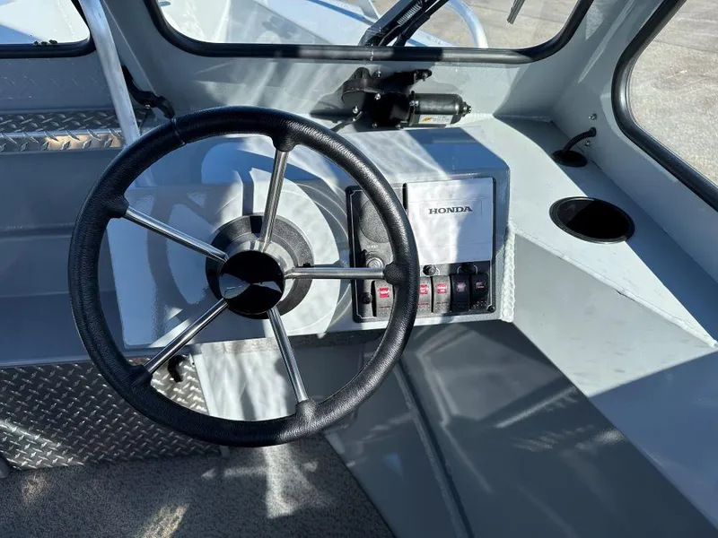 Slide: The Image of Steering wheel and controls of 2025 Hewescraft 180 Sportsman boat. - 6