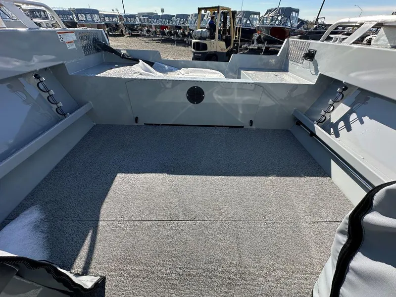 Slide: The Image of 2025 Hewescraft 180 Sportsman boat interior with spacious deck and storage compartments. - 8
