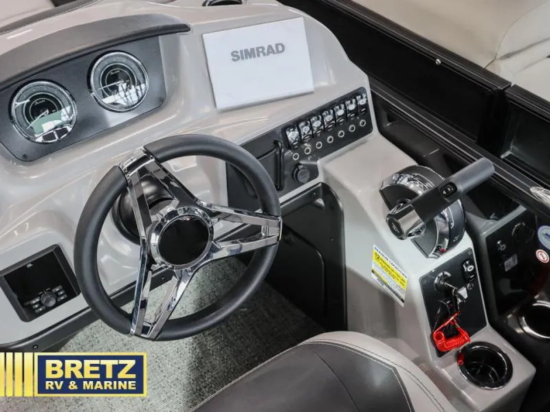 Slide: The Image of Cockpit of 2025 Aria 22QC boat with steering wheel and control panel. - 12