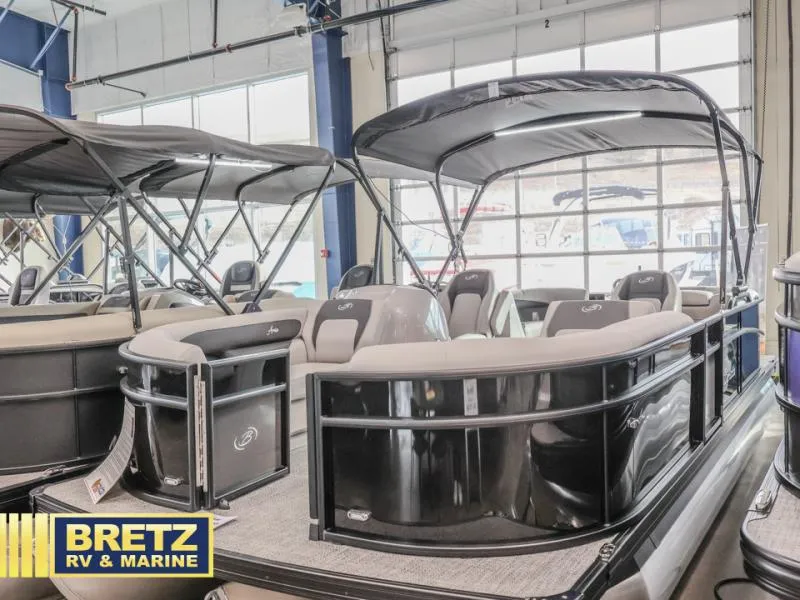 Slide: The Image of 2025 Aria 22QC pontoon boat displayed at Bretz RV & Marine showroom. - 3