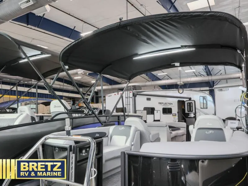 Slide: The Image of 2025 Aria 22QC boat displayed at Bretz RV & Marine showroom. - 4