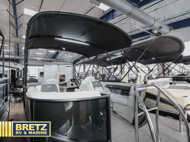 Slide: The Image of 2025 Aria 22QC pontoon boat displayed at Bretz RV & Marine showroom. - 5