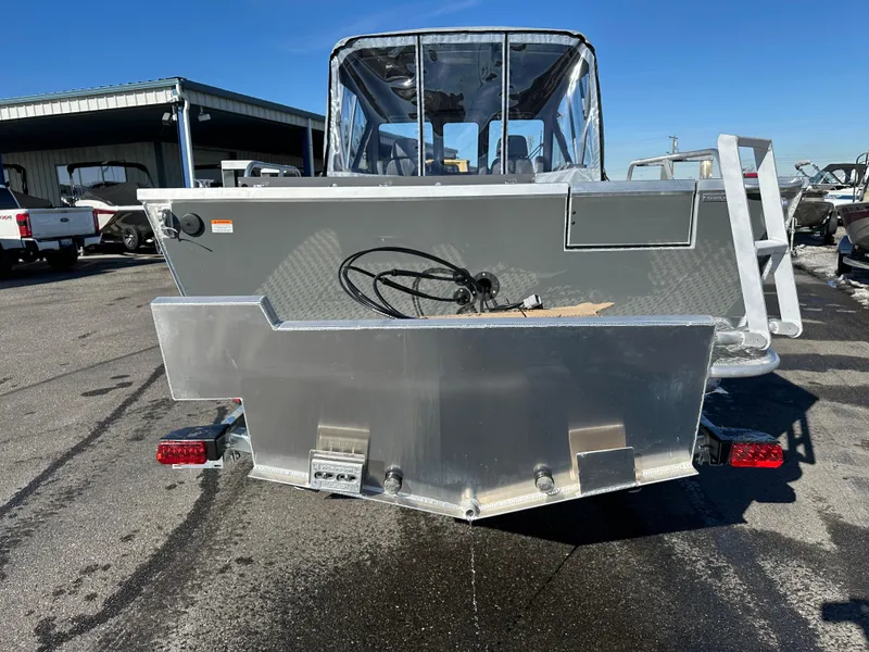 Slide: The Image of 2025 Hewescraft 210 Sea Runner ET boat, rear view, parked outdoors. - 3