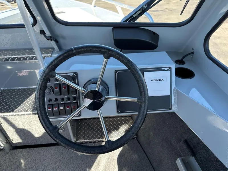 Slide: The Image of Steering wheel and dashboard of 2025 Hewescraft 210 Sea Runner ET boat. - 6