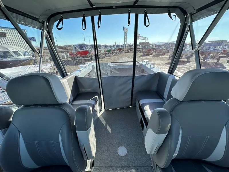 Slide: The Image of Interior of 2025 Hewescraft 210 Sea Runner ET boat with seating and windows. - 7