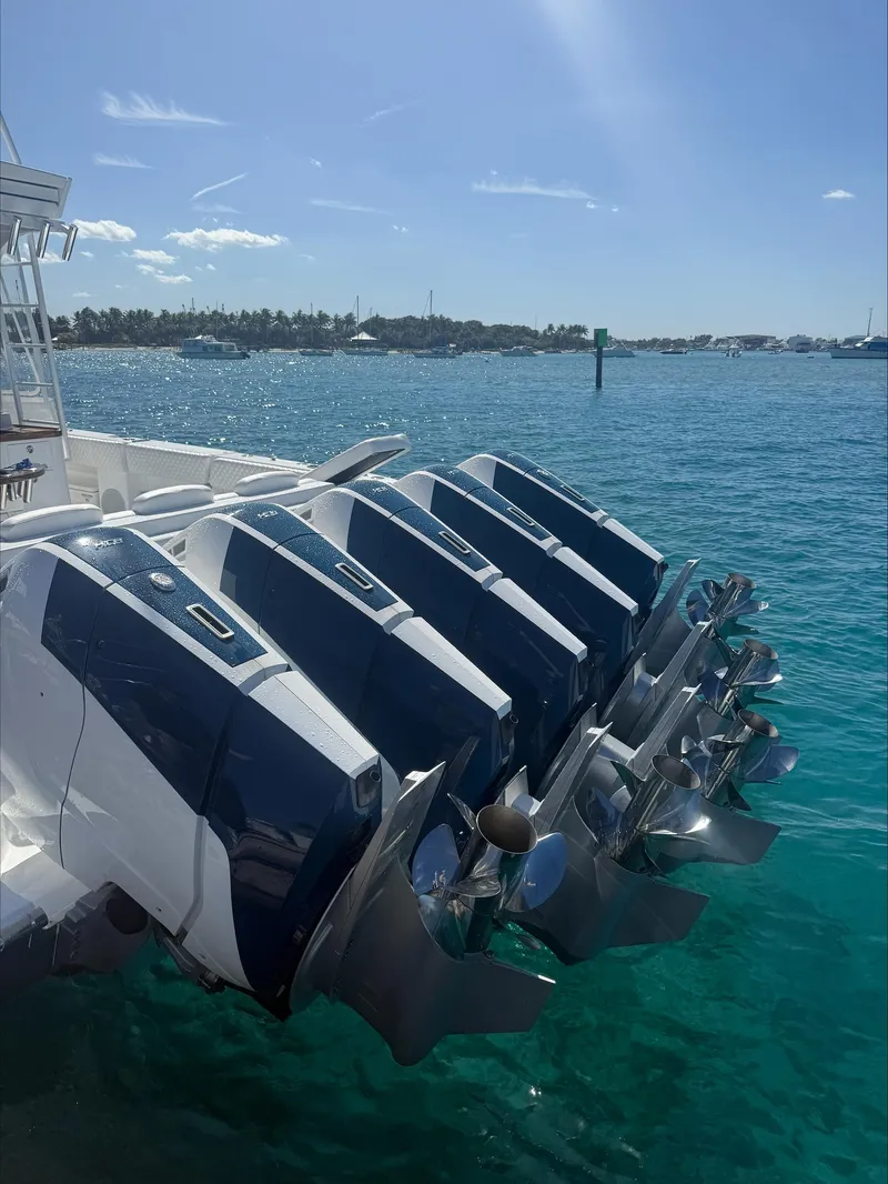 Slide: The Image of 2025 HCB 56 Suenos GIX with multiple outboard engines on clear blue water. - 15