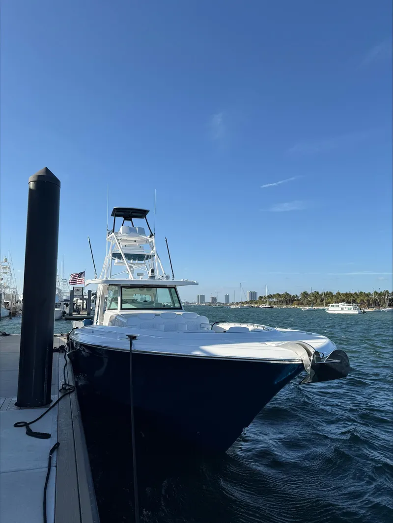 Slide: The Image of 2025 HCB 56 Suenos GIX yacht docked by the waterfront under a clear blue sky. - 16