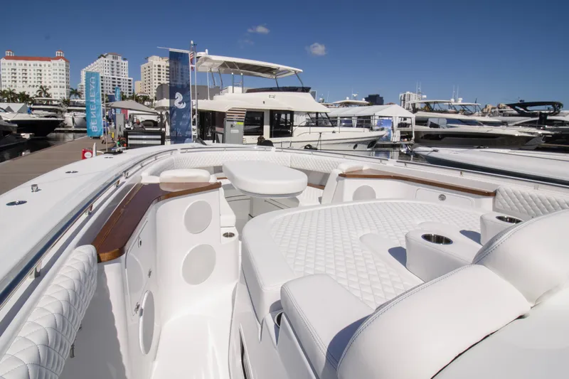 Slide: The Image of 2025 HCB 56 Suenos GIX luxury yacht interior at marina, showcasing elegant seating and design. - 8