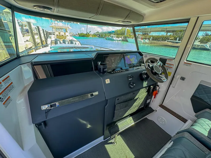 Slide: The Image of 2024 Axopar Sun Top boat interior with modern dashboard and steering wheel. - 15