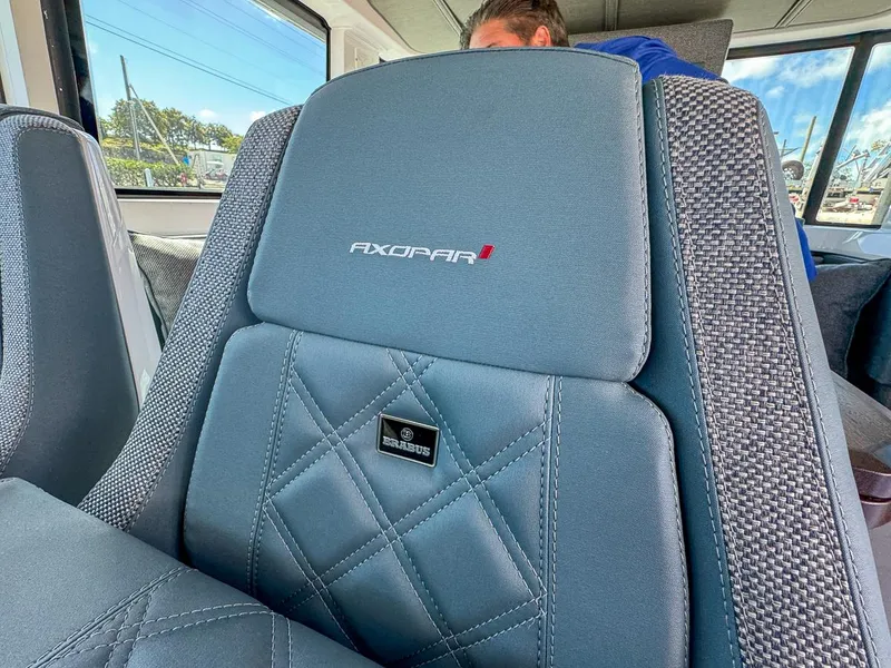 Slide: The Image of 2024 Axopar Sun Top interior seat with logo and stitching detail. - 19