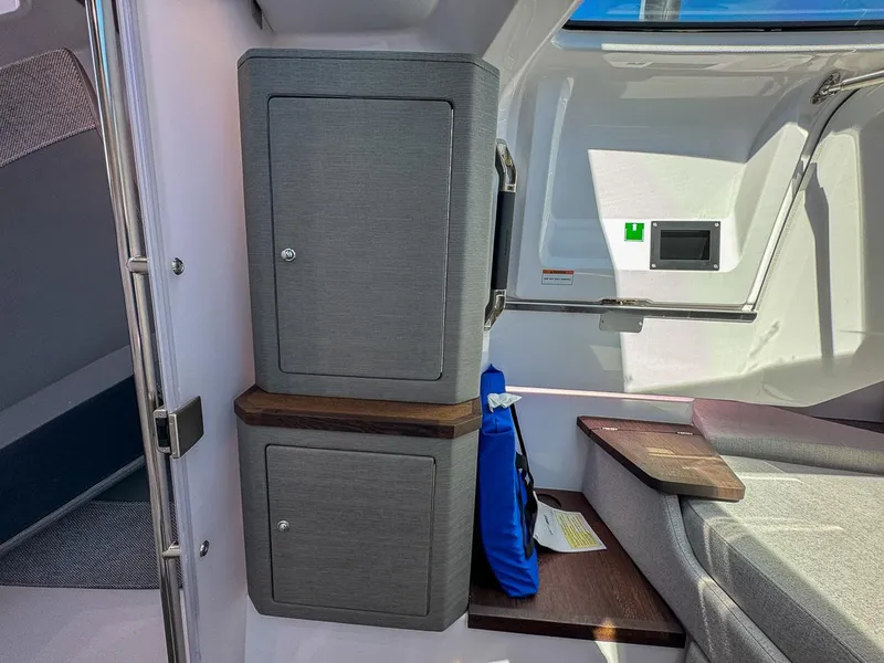 Slide: The Image of 2024 Axopar Sun Top interior with modern cabinetry and seating area. - 21