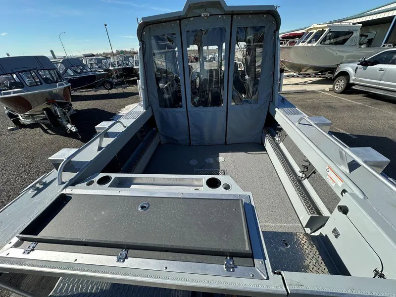 Slide: The Image of 2025 Hewescraft 210 Sea Runner ET HT boat, spacious deck, parked outdoors. - 4