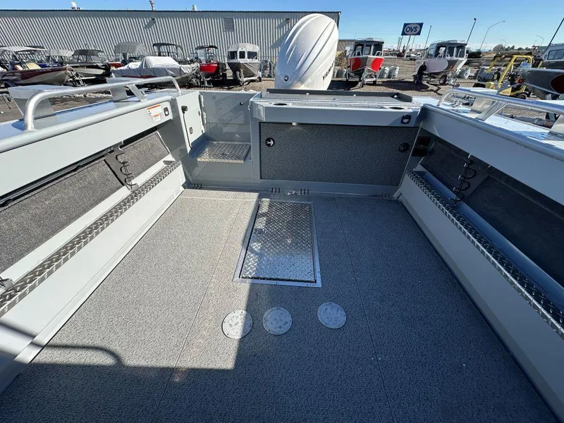 Slide: The Image of 2025 Hewescraft 210 Sea Runner ET HT boat interior, spacious deck with storage compartments. - 8