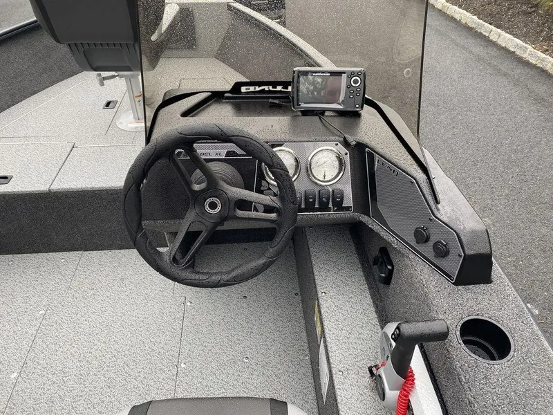 Slide: The Image of 2025 Lund 1650 Rebel XL boat dashboard with steering wheel and navigation system. - 10