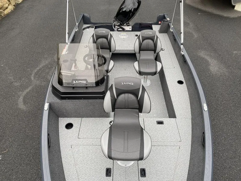 Slide: The Image of 2025 Lund 1650 Rebel XL boat interior with four seats and steering console. - 11